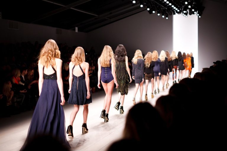 Line of runway models at the end of a show