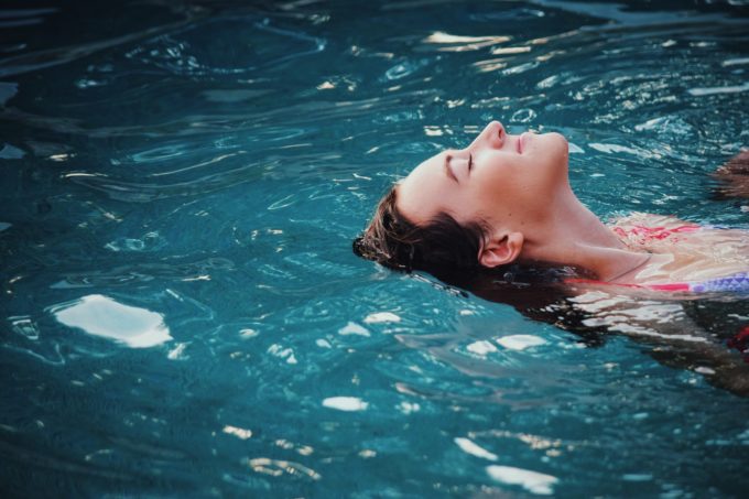 Woman floating on her back serenely in water